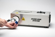 Bench-top production model heat-shrink machine for sealing hydraulic assemblies against airborne contamination